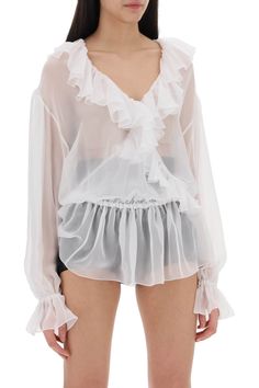 This Dolce & Gabbana blouse is made of pure silk chiffon for a transparent design. The soft and fluid silhouette features a deep V-neckline with crossed detailing, adorned with ruffles along the edges, an elasticated waistband and cuffs, and dropped shoulders with puffed sleeves. Unlined. The model is 177 cm tall and wears size IT 40. Ruffles Top, Silk Chiffon Blouse, Blouse With Ruffles, Chiffon Shirt Blouse, Women Chiffon Blouse, Dolce E Gabbana, Chiffon Blouse, White Silk, Emilio Pucci