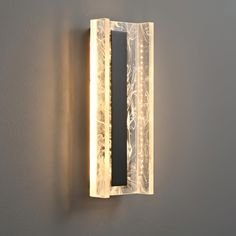 a light that is on the wall next to a mirror and some kind of object