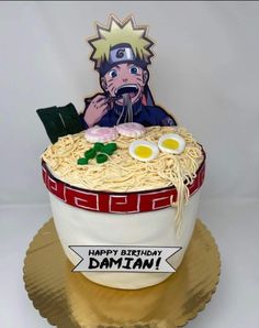 a birthday cake made to look like the character naruta eating ramen noodles