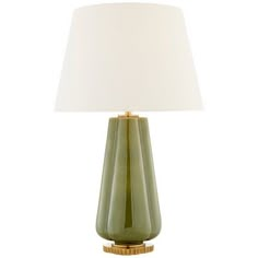 a green table lamp with a white shade