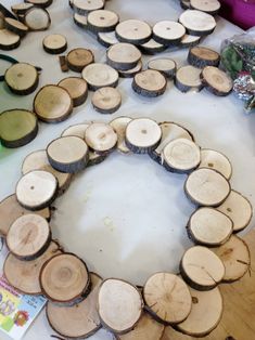 several pieces of wood arranged in a circle on top of a table with scissors and other items