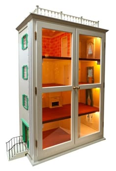 a doll house with its doors open and lights on