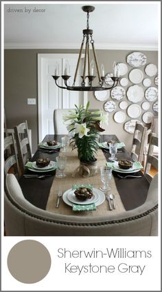 the dining room table is set with plates and flowers in vases on top of it