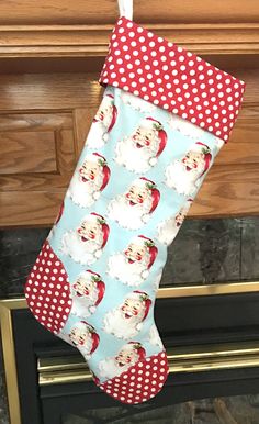 a christmas stocking hanging from a fireplace with santa claus on it's face