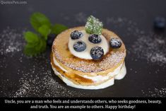 a stack of pancakes topped with blueberries and powdered sugar on a black surface