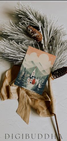 a card with a lighthouse on it next to some pine cones and fir branches in front of the text digibudha