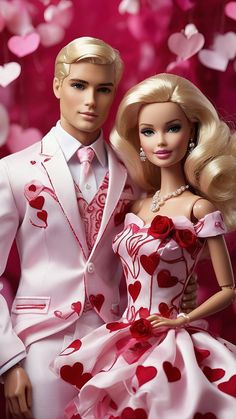 two dolls dressed in white and pink are standing next to each other with hearts all over them