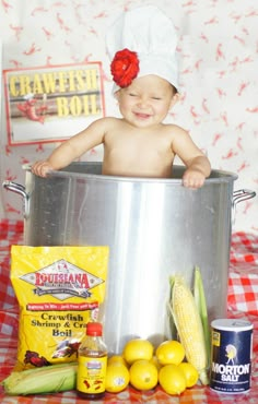 a baby in a pot with some food on the table