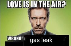 a man in a suit and tie holding a sign that says love is in the air? wrong gas leak