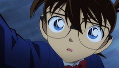 an anime character with big blue eyes wearing a suit and red bow tie looking at the camera