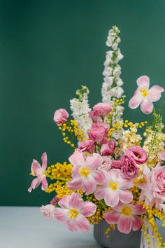 a vase filled with pink and white flowers