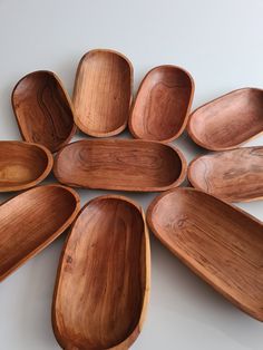 wooden spoons arranged in a circle on a white surface