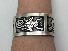 Absolutely incredible Hopi handmade cuff bracelet is made entirely of sterling silver with sterling silver overlay. The front/center of the cuff bracelet has a lizard, and the 2 sides of the cuff bracelet have kokopelli flute players (1 on each side). The amount of detail in the stampwork lizard and kokopelli designs is truly amazing!  Condition: Excellent! Artist: Signed JR Stamped/Marked: Sterling  Weight: 70 grams  Measurements: 6 inches around inside 1 1/2 inch wide gap  Fits a 6 1/2 to 7 1/ Unique Silver Stamped Cuff Bracelet, Silver Cuff Bracelet With Stamped Details, Handmade Custom Silver Bracelets, Custom Silver Handmade Bracelets, Unique Adjustable Etched Sterling Silver Bracelet, Unique Adjustable Cuff Bracelet Stamped 925, Unique Etched Sterling Silver Adjustable Bracelet, Unique Etched Adjustable Sterling Silver Bracelet, Unique Adjustable 925 Stamped Cuff Bracelet