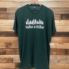 TAKE A HIKE T-SHIRT | Take a Hike Graphic Tee Shirt | Vintage Shirt | Ultra Soft Graphic Tee | T-shirt Men | Cool Shirts ntroducing our "Take A Hike" tee - more than just a t-shirt, it's an invitation to embrace the great outdoors. This isn't your ordinary tee; it's a wearable ode to the spirit of adventure. Why You'll Love It: ✨ Comfort for the Journey: Crafted with your comfort in mind, this tee isn't just about fabric; it's your companion for every step of the hiking journey. 😊 Nature Lover's Choice: A t-shirt that speaks to your love for the outdoors. Perfect for those who find solace, joy, and adventure in the beauty of nature. 👕 Adventure-Ready Style: Whether you're hitting the trails or just want to carry the essence of nature with you, this t-shirt effortlessly blends comfort wit Take A Hike Shirt, Graphic Tee T-shirt With Crew Neck For Hiking, Green Short Sleeve T-shirt For Outdoor, Green Graphic Tee For Outdoor, Green T-shirt For Outdoor Activities, Crew Neck T-shirt With Letter Print For Hiking, Green Crew Neck T-shirt For Outdoor, Green Crew Neck T-shirt For Outdoor Activities, Relaxed Fit Crew Neck T-shirt For Outdoor