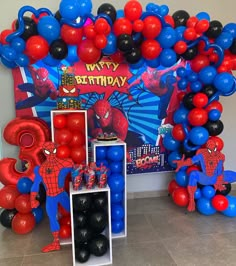 a birthday party with balloons and spiderman decorations