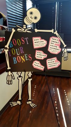 a skeleton holding a sign that says root your bones on it with words written in different languages