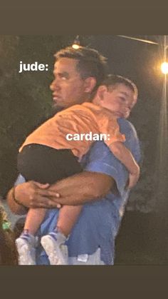 a man holding a child in his arms with the words dude cardan on it