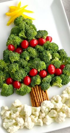 a christmas tree made out of broccoli and cauliflower on a plate