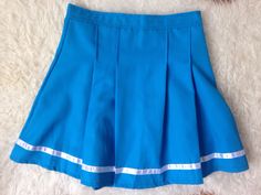 Vintage Pleated Mini Skirt | Tennis Skirt | 90s Mini Skirt | 80s Blue Mini Skirt | Sports Skirt | Activewear Skirt | Preppy Grunge Skirt |s | cheerleader skirt  1980s cheerleader sporty, bright blue mini skirt with a reflective stripe at the bottom.  Great condition, no noticeable flaws. Size: about an S/M Small / Medium US 2 - 6 or UK 6- 10 depending whether to wear it higher on the waist or lower at the hips. Measurements laid flat at the waist: 13.5 in. So waist would be 27 in. Max. PLEASE  N Cheap Y2k Style Blue Skirt, Retro Blue Fitted Skort, Blue Pleated Skirt For School, Blue Pleated Tennis Skirt For School, Retro Fitted Blue Mini Skirt, Retro Pleated Tennis Skirt For School, Retro Pleated Skort For School, Blue Retro Cotton Skort, Blue Mini Skirt For School Uniform In Summer