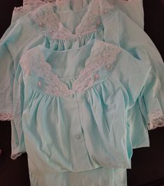 Lovely pajama and robe matching set in light blue with Chantilly lace, rose appliques and pockets on top and robe. Wake up in the mornings in this set of  PJ's and robe or in the evening as a lounge set.  Size: Medium Set: Shirt and Pants & Robe Material: Nylon Condition: Overall very good vintage condition.  Vintage linens are at least 20-50 years old and therefore; some items may have a few minor imperfections.  If you have any questions about this item, please let me know and I will do my bes Long Sleeve Sleepwear With Lace Trim For Pajama Party, Long Sleeve Lace Trim Sleepwear For Sleepovers, Long Sleeve Sleepwear With Lace Trim For Loungewear, Matching Long Sleeve Sets For Daywear, Light Blue Cotton Sleepwear For Home, Light Blue Cotton Sleepwear, Long Sleeve Lace Trim Sleepwear For Bedtime, Long Sleeve Lace Trim Sleepwear, Long Sleeve Blue Nightgown For Home