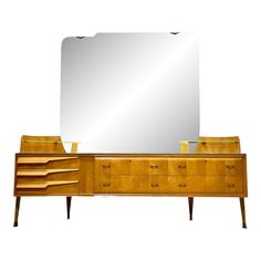 a large mirror sitting on top of a dresser next to a wooden cabinet with drawers