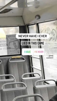 the inside of a bus with seats and graffiti written on the wall next to it