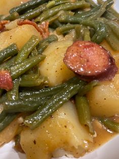 green beans, potatoes and sausage on a white plate