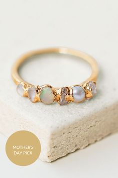 A nuanced take on classic ombre, this iridescent ombre ring features a collection of shimmering stones in various shades of white. With Herkimer diamond, pearl, quartz, opal, moonstone, and white topaz stones, these raw gemstones range from warm creams to the coolest whites. Stackable Moonstone Ring In Fine Jewelry Style, Elegant Iridescent Birthstone Jewelry, Opal Moonstone Ring For Anniversary, Iridescent Fine Jewelry Ring For Anniversary, Delicate Opal Ring For Anniversary, Elegant Iridescent Opal Ring For Anniversary, Elegant Iridescent Crystal Ring For Wedding, Elegant Iridescent Crystal Wedding Ring, Jewel Photography