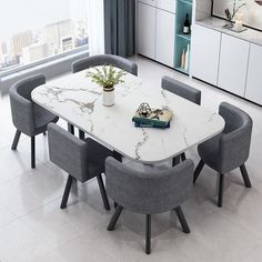 a dining table with chairs around it and a book on the table next to it