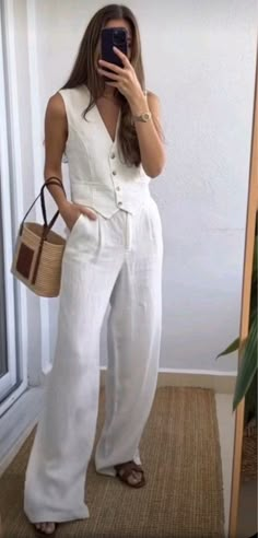 White vest and pants set with dark leather sandals and a basket bag for a purse. Summer outfits, travel outfits, outfits for hot weather, work outfits.  Follow my shop @maggierussell1 on the @shop.LTK app to shop this post and get my exclusive app-only content!  #liketkit #LTKstyletip #LTKworkwear #LTKtravel @shop.ltk   fashion inspo | fashion outfits | fashion aesthetic | outfit ideas | clothes for women | luxury aesthetic | minimalist | chic | old money aesthetic | coastal granddaughter | vacation outfits | European outfits | clothing pictures | young adult style | blazer outfit | linen outfit | pearls | necklace | revolve | fashion icon | fashion design | clothes design | clean girl aesthetic | fashion blogger | summer day outfit | outfit | summer 2024 fashion | nighttime outfits | eleg Europe Outfits, Elegante Casual, Vest Outfits, Looks Chic, Summer Fashion Outfits, Looks Style, Mode Inspiration, White Pants