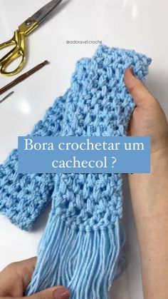 someone is crocheting a blue scarf with scissors