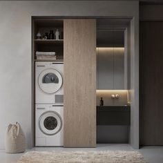 a washer and dryer in a room with wooden cabinets on either side of the door