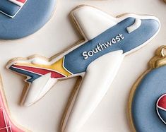 decorated cookies are arranged in the shape of airplanes