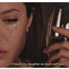 a woman holding a wine glass in front of her face with the words i'll teach my daughter so much self love