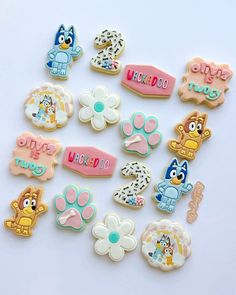 there are many different decorated cookies on the white table together, including one for each cookie