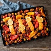 a black tray filled with lots of food on top of a wooden table