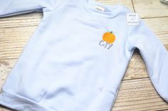 Adorable Monogrammed baby blue sweatshirt with pumpkin design.   These will be perfect for pumpkin patch or halloween photos.  (Look for a santa design also in my shop).   If you prefer a PLAIN monogrammed sweatshirt (no pumpkin design) then your options for monogram: curved collar (first name), center chest (first name or monogram), left chest (monogram).   In Message to seller, include  1) FULL NAME for monogram OR straight line initials - and which you prefer. Mono will show last initial larg Fitted Sweater For Fall, Customizable Cotton Fall Sweater, Customizable Cotton Sweater For Fall, Customizable Cute Tops For Fall, Personalized Cotton Sweatshirt For Fall, Cute Custom Embroidered Tops For Fall, Blue Pre-shrunk Sweatshirt For Fall, Personalized Crew Neck Sweatshirt For Fall, Cute Tops With Custom Embroidery For Fall