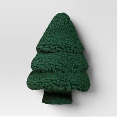 a green towel hanging on the wall next to a small christmas tree ornament