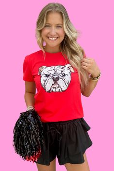 Make a statement this Game Day with this fun top featuring a large sequin bulldog head on the center of the tee, a crew neckline, short sleeves, and a slightly fitted bodice throughout the body. This top can easily be styled with all most all types of bottoms and a pair or sneakers or cowgirl boots! Available in XS-3X. **Recommend sizing up for a larger chest & sizing up 2 sizes if you want a loose fit. SIZE BUST WAIST LENGTH XS 35 35 22 SMALL 36 36 22.5 MEDIUM 37 37 23 LARGE 38 38 23.5 XL 41 41 Large Sequins, Waist Length, Cowgirl Boots, Fitted Bodice, Nice Tops, Game Day, Crew Neckline, Red Color, Bulldog