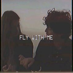 two people standing next to each other with the words fly with me in front of them