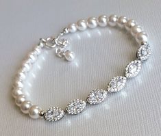 Wedding White Pearl Cubic Zirconia Marquise Silver Dainty Bridal Bracelet. PLEASE READ ITEM DESCRIPTION before placing your order, and contact me with any questions! BRACELET is about 7.25 inches (18.4cm) long plus 1 inch extender chain. MATCHING EARRINGS: https://www.etsy.com/listing/568448512/pearl-bridal-earrings-white-pearl-dainty?click_key=2a16a185f55cbc4f0b260031a3b109ec49d87540%3A568448512&click_sum=5d253fb7&ref=shop_home_active_8&sts=1 BRIDAL BRACELETS SECTION: https://www.etsy.com/shop/LanaChayka?ref=seller-platform-mcnav§ion_id=11638942 BRIDAL EARRINGS SECTION: https://www.etsy.com/shop/LanaChayka?ref=seller-platform-mcnav§ion_id=11638940 BRIDAL JEWELRY SETS SECTION: https://www.etsy.com/shop/LanaChayka?ref=seller-platform-mcnav§ion_id=25839214 BRIDAL NECKLACES SECTION: https://w Bridal Pearl Jewelry, Bridal Bracelets, Pearl Bracelet Wedding, Zircon Bracelet, Pearl Bridal Jewelry, Bracelet Pearl, Bracelet Wedding, Bridal Earrings Pearl, Dainty Bracelet