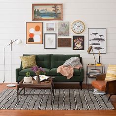 a living room filled with furniture and lots of pictures on the wall above it's coffee table