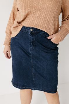 Every woman needs a classy denim skirt in her life! The 'Krista' gives denim an elegant twist with it's straight pencil style and solid dark wash shade. Plus, we love the subtle stretch which will keep you comfortable all day long! Pair the 'Krista' with a turtleneck sweater and boots for a day shopping with friends or with a floral blouse and loafers for the office. Exclusively designed with you in mind. 97% Cotton 3% Spandex Machine Wash Cold Do Not Bleach Hang to Dry Low Iron if Needed 2" Bac Classic Medium Wash Denim Skirt For Work, Classic Dark Wash Denim Skirt For Work, Medium Wash Straight Leg Denim Skirt For Work, Denim Pencil Skirt For Fall, Dark Wash Denim Skirt For Fall Workwear, Classic Fitted Denim Skirt In Denim Blue, Classic Fitted Denim Skirt For Fall, Dark Wash Straight Leg Skirt For Work, Classic High Waist Dark Wash Denim Skirt