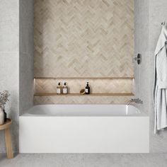 a white bath tub sitting next to a wooden shelf