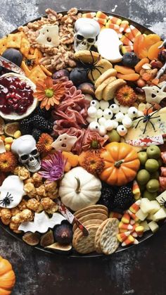 a platter filled with lots of different types of halloween food and decorations on top of it