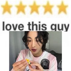 a person holding a yellow object in their hand and five stars on the wall behind them