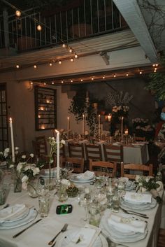 the table is set with white plates and silverware for an elegant dinnereon party