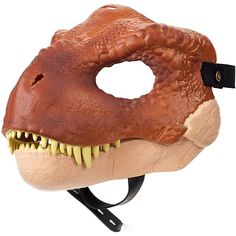 a dinosaur mask with sharp teeth is shown on a white background and has a black tag attached to it's mouth