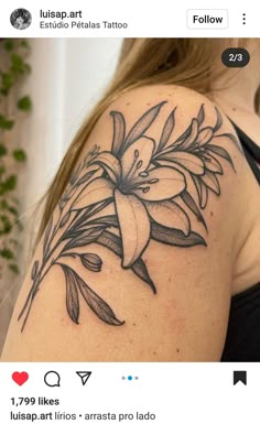 a woman's shoulder with a flower tattoo on it