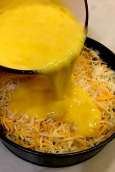 cheese being poured into a skillet filled with grated shredded cheese and melted cheese